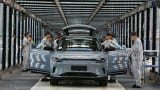 Employees work on the assembly line of new energy vehicles at a factory of Chinese EV startup Leapmotor on April 1, 2024 in Jinhua, Zhejiang Province of China.