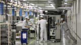 Employees move semiconductor testers on the assembly line of the Advantest Corp. plant in Ora, Japan on Aug. 10, 2012.