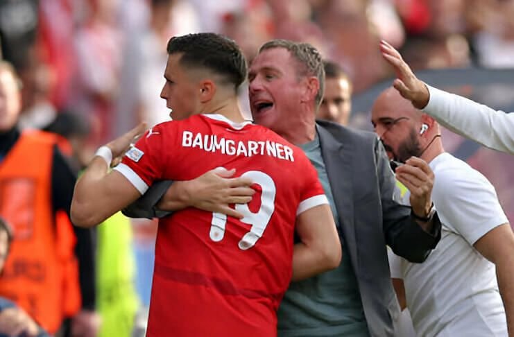 Ralf Rangnick mengamankan kacamatanya saat memeluk Christoph Baumgartner Getty Images