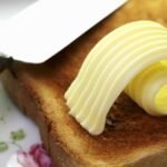 Pakai Butter atau Minyak Nabati? Kenali Bedanya Biar Kue Makin Sempurna 0 Slice of toast with curl of butterjpgThe woman - Info Malang Raya